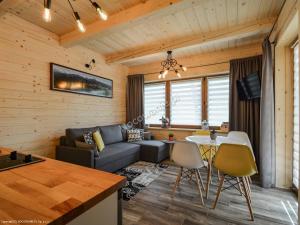 a living room with a couch and a table at Domki "Na Ugorach" Apartamenty in Zakopane