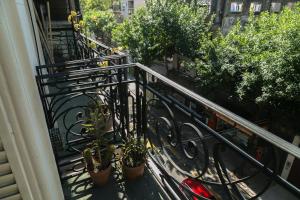 a balcony with potted plants on a building at Experiencia Congreso in Buenos Aires