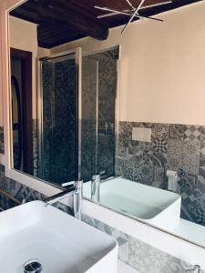 a bathroom with a tub and a sink and a mirror at Linhouse in Rome