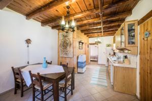 a kitchen and dining room with a table and chairs at ARADENA TRADITIONAL House 2 in Arádhaina