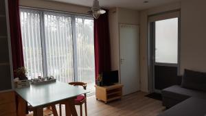 a living room with a table and a large window at Luxe Studio Bovenweg in Rhenen