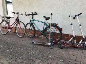 three bikes parked next to a building with mopeds at Ferienhaus Crowson in Cabarz