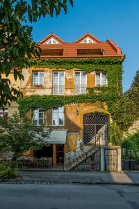 a building with ivy growing on the side of it at Boutique Hotel Carpe Diem in Prešov