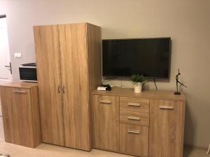 a large wooden entertainment center with a flat screen tv at Domek na Jasnej in Muszyna