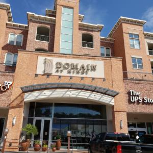 a store front of a building with a sign on it at Domain at Kirby in Houston