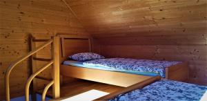 a bedroom with two bunk beds in a wooden cabin at Mountain peaks Apartment with Sauna in Gozd Martuljek +66 photos