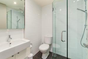 a bathroom with a toilet and a glass shower at Horoeka on Hallenstein in Queenstown +10 photos