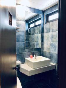 a bathroom with a white sink and a window at Lai Chi Te Hotel in Tainan