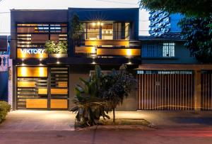 a house with a lit up facade at night at Viktory Boutique Hotel in Medellín