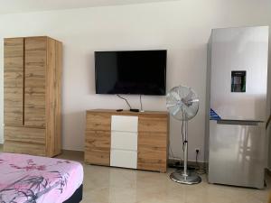 TV tai viihdekeskus majoituspaikassa Studio ds résidence sécurisée avec vue & accès à la mer .