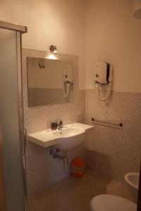 a bathroom with a sink and a mirror at Affittacamere Vista Mare in Porto Azzurro