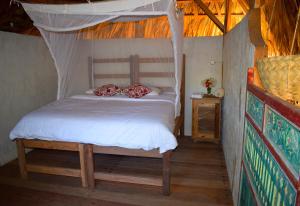 a bedroom with a bed in a tent at Utopia Rote Lodge in Nembrala