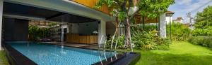 a swimming pool in the backyard of a house at M5 Hotel in Chiang Mai