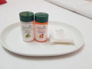 two bottles of moisturizers sitting on a white plate at Hotel Kanak Sagar in Ajmer