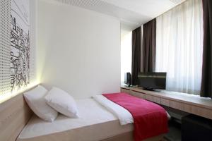 Letto o letti in una camera di Hotel Cosmopolit