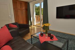 a living room with a couch and a table at Haus Mariedl in Reutte