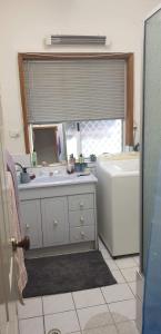 a bathroom with a sink and a tub and a window at York's Lookout Lodge Bed And Breakfast in York