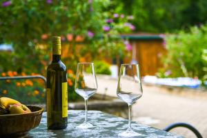 a bottle of wine and two wine glasses on a table at Apartment LIVI in Mikulov