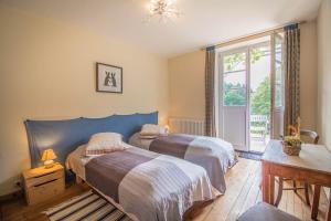 a bedroom with two beds and a window at Villa Louisental - Gruppenunterkunft für Selbstversorger in Le Hohwald