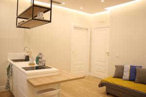 a kitchen with a sink and a couch in a room at La Casa nel Parco in Naples +30 photos
