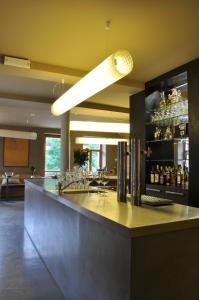 a lobby with a bar with a lot of alcohol at Hotel Kokořín in Kokořín