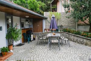 a patio with a table and chairs and an umbrella at Apartment LIVI in Mikulov