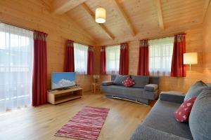 a living room with a couch and a tv at Ferienwohnung Lechenhof in Söll