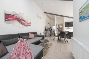 a living room with a couch and a dining room at Apartments Luky in Zadar