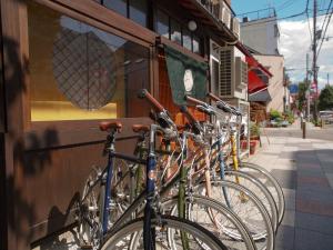 a row of bikes parked on the side of a building at Kyoto Machiya Cottage Karigane in Kyoto