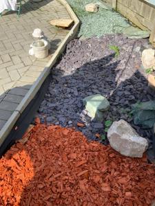 a garden with rocks and a green rock at Stanwell Stansted Airport in Takeley