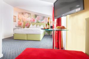 Tempat tidur dalam kamar di Hotel Ambassador