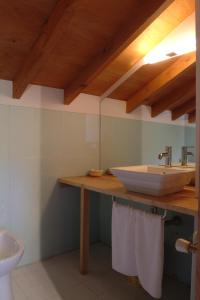 a bathroom with a sink and a toilet at Casa Rural Vilaboa in Allariz