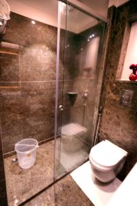 a bathroom with a toilet and a glass shower at Hotel City Pride in New Delhi