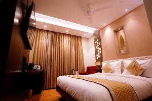 a hotel room with a large bed and a window at Hotel City Pride in New Delhi