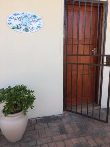 a door with a plant in a pot next to a building at Forget-Me-Not Cottage in Krugersdorp