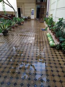 a tiled floor with a puddle of water in a building at Uvaysiy family guest house in Margilan