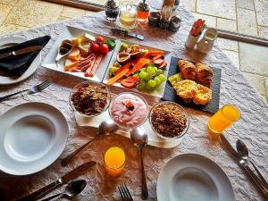 a table topped with plates and bowls of food at Wild Horses Lodge in Harrismith