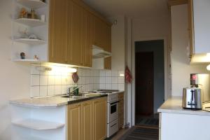 a kitchen with a sink and a stove top oven at City centre apartment Siilinjärvi in Siilinjärvi