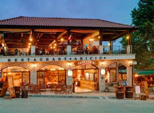 a building with a restaurant with tables and chairs at Hotel Iceberg in Balchik