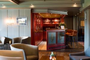 a bar in a restaurant with chairs and a table at Geilo Hotel in Geilo