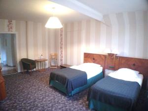 Säng eller sängar i ett rum på Markgrafenmühle Pension und Ferienwohnungen