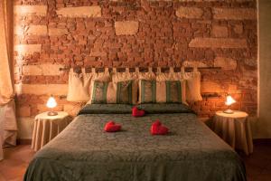 Postel nebo postele na pokoji v ubytování Anfiteatro B&B