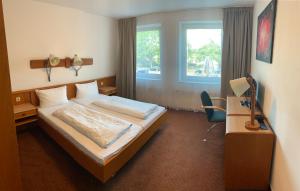 
Ein Bett oder Betten in einem Zimmer der Unterkunft Hotel Rahlstedter Hof
