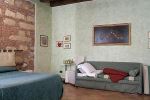Postel nebo postele na pokoji v ubytování Anfiteatro B&B
