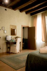 Postel nebo postele na pokoji v ubytování Anfiteatro B&B