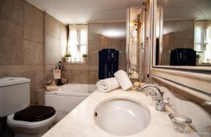 a bathroom with a sink and a toilet and a tub at Villa Virginaki in Portaria +38 photos
