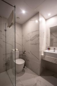 a bathroom with a toilet and a sink and a shower at Narcissos Waterpark Resort in Protaras