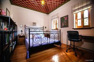 a bedroom with a bed and a chair in a room at Villa Virginaki in Portaria
