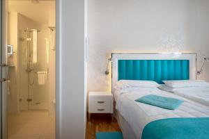 Ένα ή περισσότερα κρεβάτια σε δωμάτιο στο Piccolo Grand Hotel