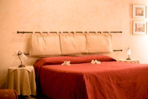 Postel nebo postele na pokoji v ubytování Anfiteatro B&B